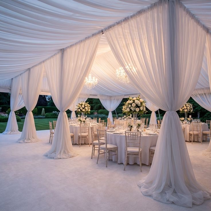 Voile drapery panels in white over an elegant outdoor celebration