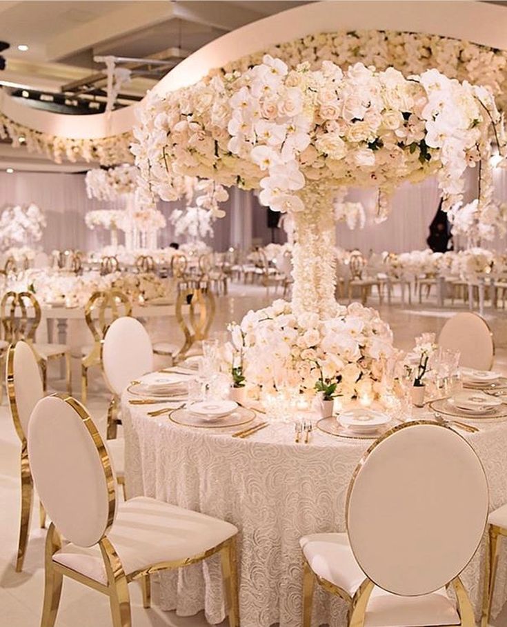 Towering floral centerpiece above a rose-textured tablescape